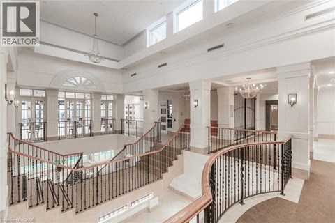 A large, well-lit, and spacious interior of a building with a curved staircase.