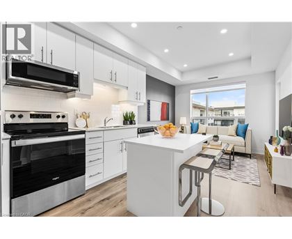 A modern kitchen with white cabinets and stainless steel appliances.