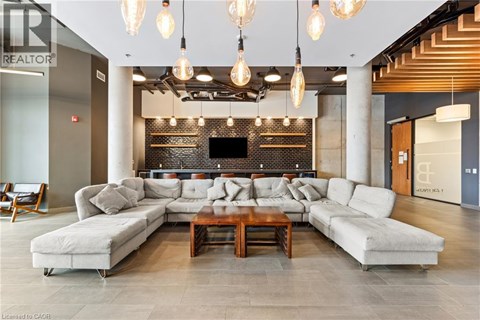 A modern living room with a large sectional sofa and a coffee table.