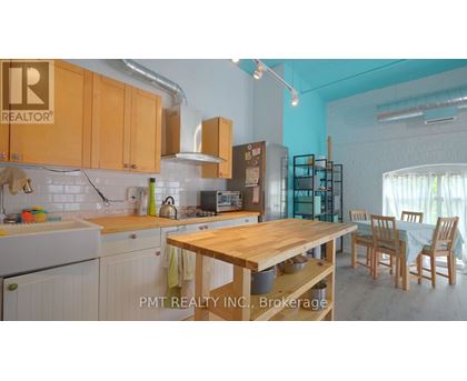A kitchen with wooden cabinets and a table.
