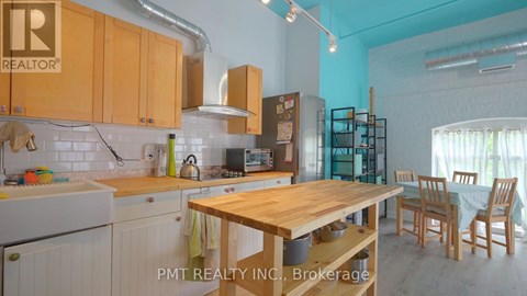A kitchen with wooden cabinets and a table.