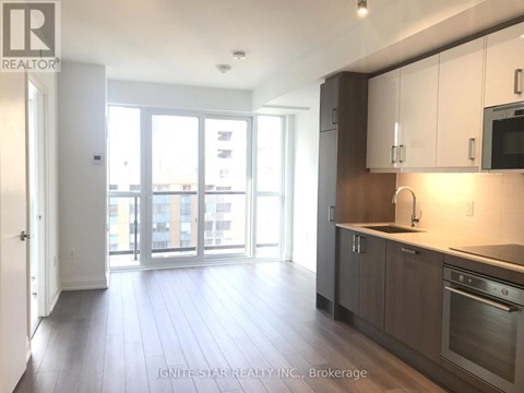 A kitchen with white cabinets and a stainless steel oven.