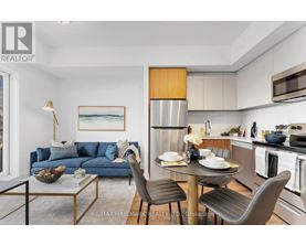A modern kitchen with a dining table set for two.