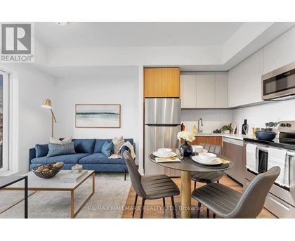 A modern kitchen with a dining table set for two.