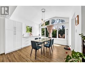 A dining room with a glass table and chairs.