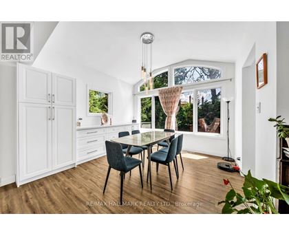 A dining room with a glass table and chairs.