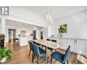 A modern kitchen with a dining table and chairs.