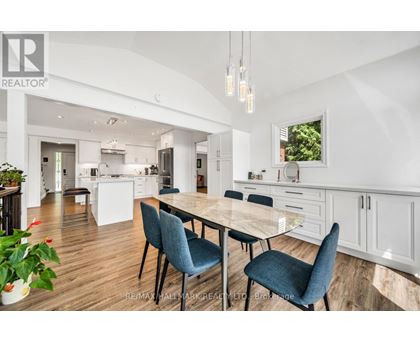 A modern kitchen with a dining table and chairs.