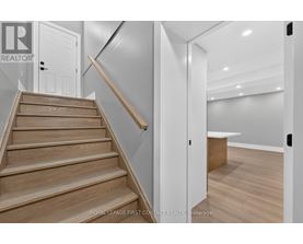 A staircase with wooden steps and a white door.