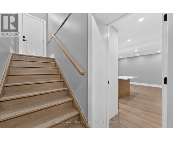 A staircase with wooden steps and a white door.