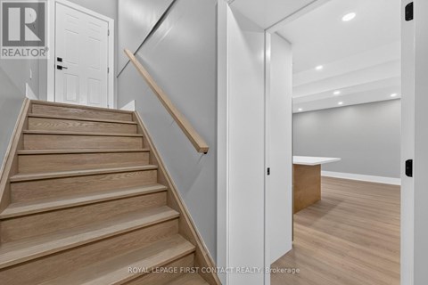 A staircase with wooden steps and a white door.