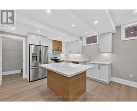 A modern kitchen with a wooden island and stainless steel appliances.