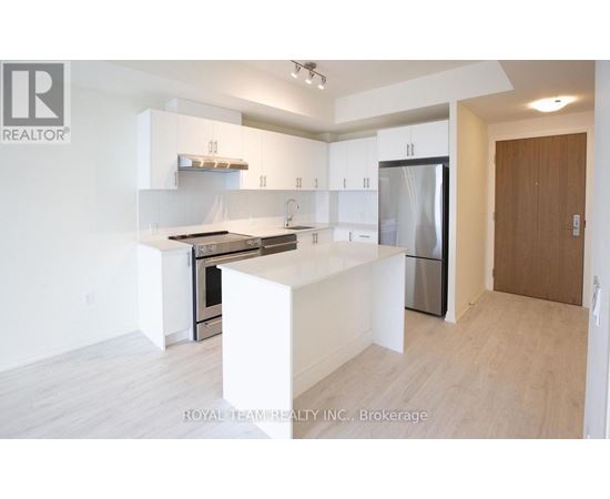 A white kitchen with a refrigerator, oven, and sink.