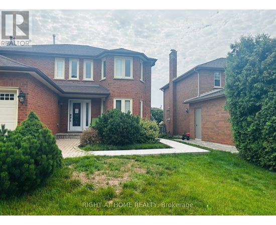 A house with a red brick exterior and a white garage door is for sale.