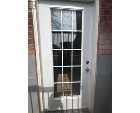 A white door with a glass window and a metal handle.