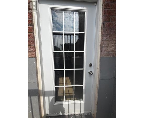 A white door with a glass window and a metal handle.