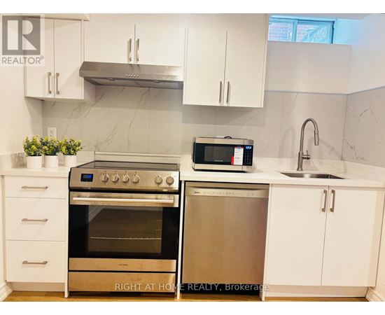 A kitchen with a stainless steel oven and microwave.