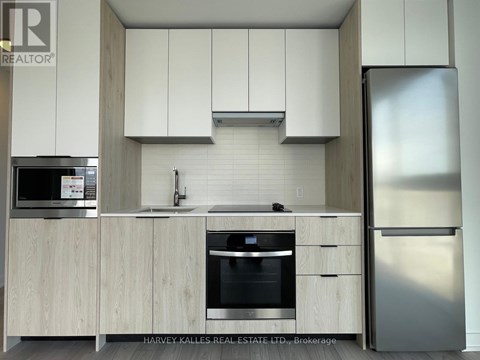 A modern kitchen with wooden cabinets and stainless steel appliances.