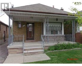 A house with a porch and a front yard.