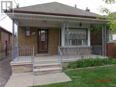 A house with a porch and a front yard.