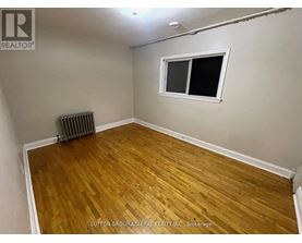 A room with a wooden floor and a window.