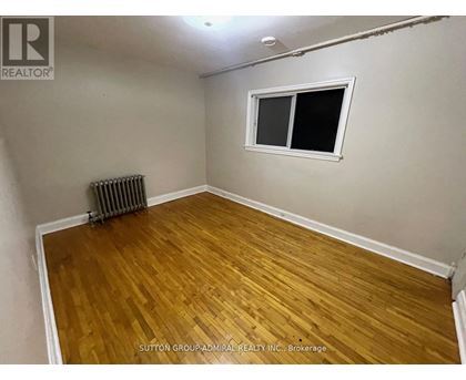 A room with a wooden floor and a window.