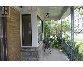 A balcony with a brick wall and a metal railing.