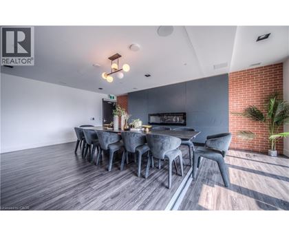 A modern dining room with a long table and chairs.