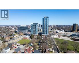 A cityscape with a mix of residential and commercial buildings, with a clear blue sky above.