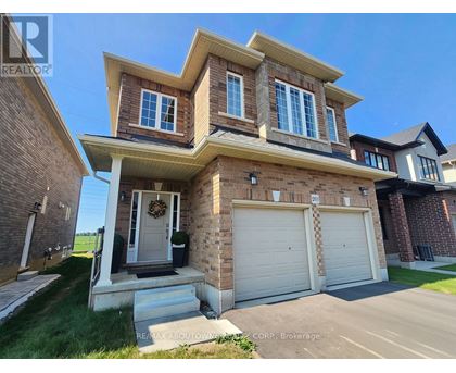 A two-story house with a garage is for sale.