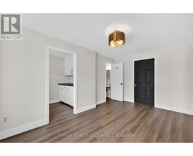 A room with a black door and a white cabinet.
