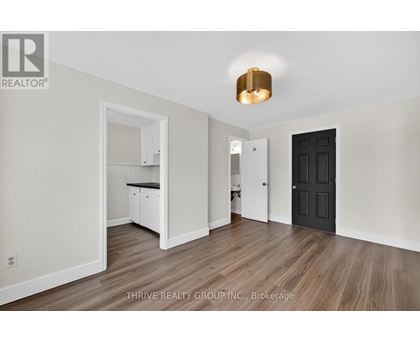 A room with a black door and a white cabinet.