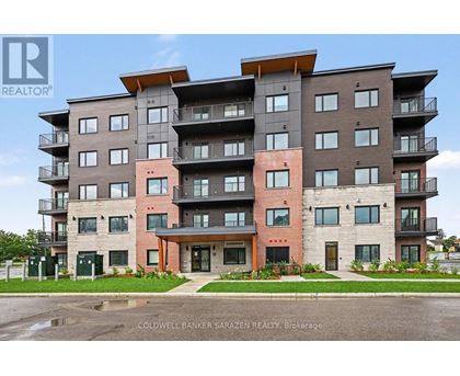 A large apartment building with a red door in the front.