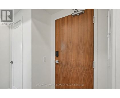 A brown door with a silver handle and lock.