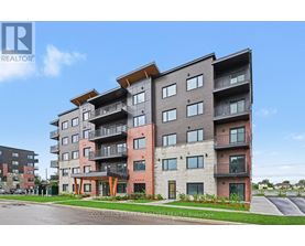 A modern apartment building with balconies and multiple stories.