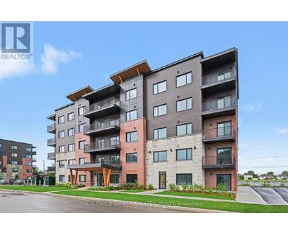 A modern apartment building with balconies and multiple stories.
