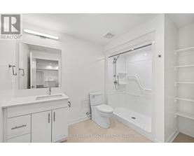 A white bathroom with a toilet, sink, and bathtub.