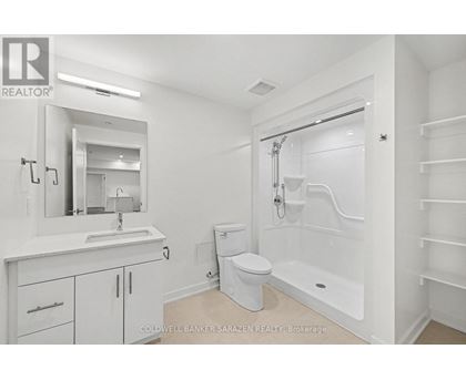 A white bathroom with a toilet, sink, and bathtub.