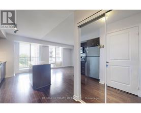 A modern kitchen with a refrigerator and a countertop.