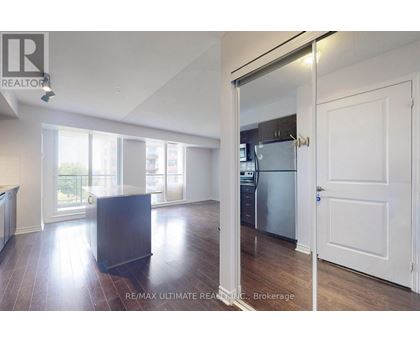 A modern kitchen with a refrigerator and a countertop.
