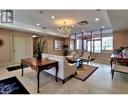 A living room with a wooden table and white chairs.