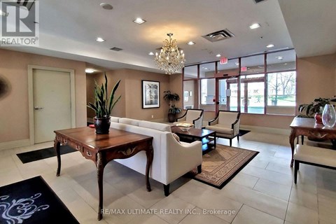A living room with a wooden table and white chairs.
