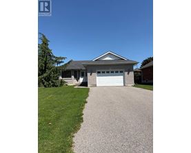 A house with a garage and a driveway in front.