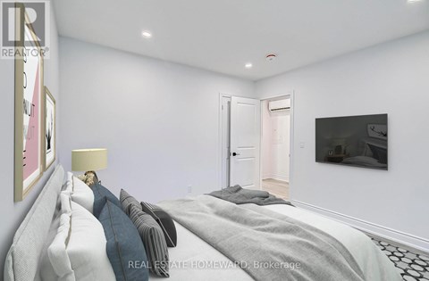 A bedroom with a bed, lamp, and painting on the wall.