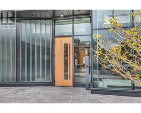 A glass door with a wooden frame is the entrance to a building.