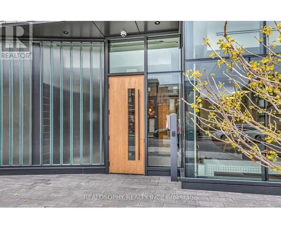 A glass door with a wooden frame is the entrance to a building.