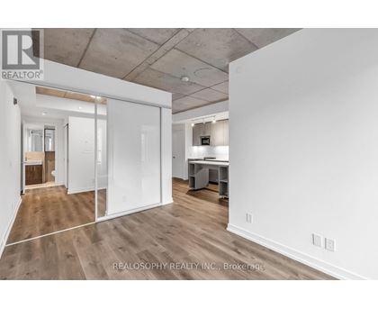 A spacious office room with a desk and a whiteboard.