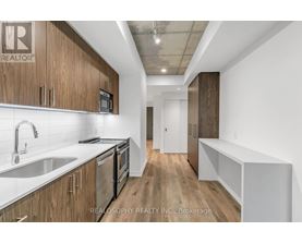 A kitchen with wooden cabinets and stainless steel appliances.