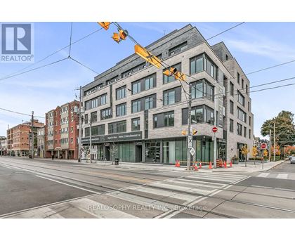 A street view of a building with the sign REALOSOPHY REALTY INC. Brokerage.