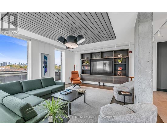 A living room with a green sofa and a grey armchair.